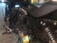 Hacked off my stock license bracket and fabricated a mount to attach it to my passenger peg down low on the bike.