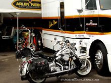 Sturgis 2004- Sweet Freedom parked at the Arlen Ness booth where I has a Ness triple-tree adapter installed. Like everything else 'except FLSTS', the un-standard tree of of the FLSTS will not accept many add-on devices, without such an adapter (only made by Ne$$), which I needed for my new instrument cluster.