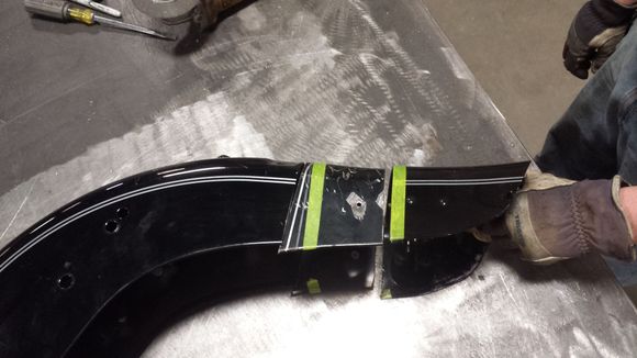 Showing the cut section. As you can see, I left a little extra on the donor piece for 2 reasons: You can always cut more off.
In order to match the roll of the rear of the fender, we tacked the rear face in place, then slipped the side skirts of the donor section into the stock fender. This allowed us to bend/shape the fender to match the natural curve, and also gave us a solid line to mark and cut the spliced section.