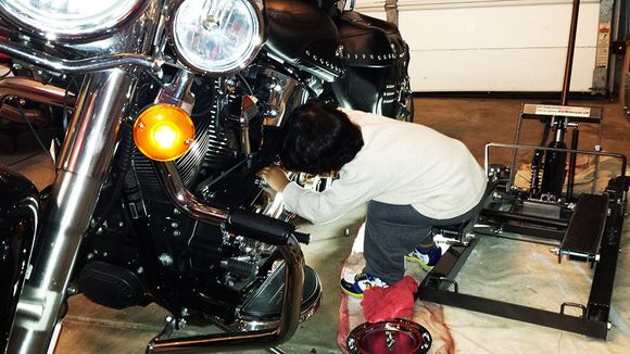 My grandson (age 1 1/2 yrs old) helping me adjust the clutch.  Good use of the floor jack.