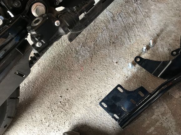 The rear brake master was in the way so I cut it out. Who needs brakes anyway. Kidding. The plate needed to be cut to clear the brake master resivoir so I chopped the upper forward mount hole off enough to clear the resivori about 1/4 to 3/8 of an inch. You can see the bracket on the ground here.