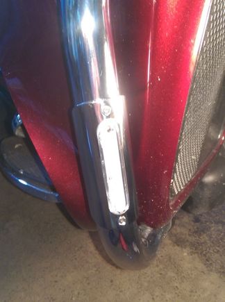 There's a clear cover under the entire polished stainless piece, and it's got silicone all the way around to seal the assembly.  The wiring hole got gooped, too.  Then the metal piece pops on over that, and is secured with the screws.