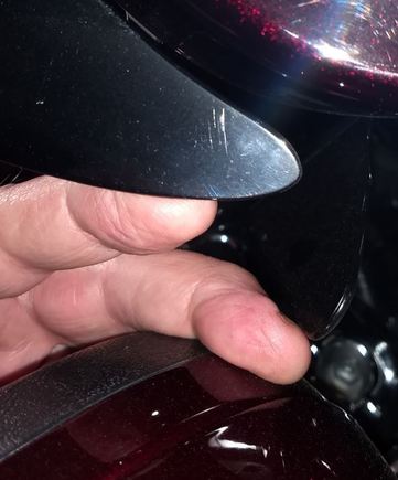 The top black thing is the fairing vent, at full right lock.  The other finger is at the tip of the wing, sitting on the lower.