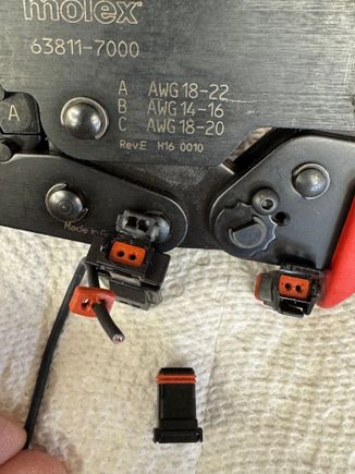 If you are building a connector you will remove the seal from the connector, slide the wire through and install a pin. After you seat the pins in the connector put a little dielectric grease on the edge of the seal and on the wire towards the pin. Then slide the seal into the connector. 
