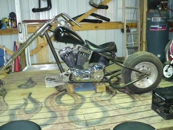 Trike 04 
  Just had to see what a wheel looked like being mine did not arrive yet.
But at this point the bike now has a 111ci SS Evo motor, SS carb with a New revtech 5 speed. For this trike I have to offset the tranny 1.5" So I picked up a 1.5 chrome offset primary for the 89-93 softail along with a used outer primary for the same year. I think I had about 80 bucks in those 2 pieces and the inner was brand new with bearing and seals.. The front end I have on the bike is a American Suspension 63mm inverted with the phantom brake line and built in front caliper 10 over with 3 degrees at the tree . Yes Look Mom no brake lines here!! a nice little piece I picked up for about 800 brand new well almost new for one of thise guys with to much money that dropped 2500 on the 10 over front end and then thought he wanted a springer after 2 weeks. Oh well one of those my loss you gain deals.