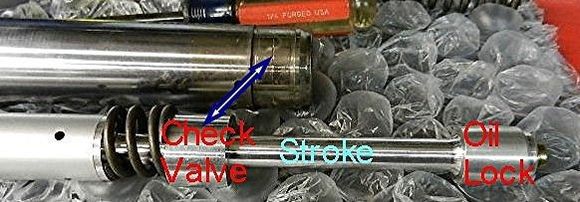 The check valve is located inside of the bottom of the fork.  Do not remove it, I am just showing what it looks like.  The top out spring is above & resting on the check valve and the shaft goes through the fork tube/check valve and the oil lock is installed on the end of the shaft.