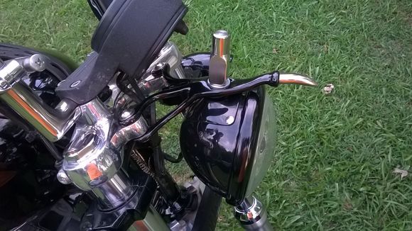 The head light bracket is 3/8" stainless rod forged and welded. It has the ball and socket to match the light and adjust the same as the stock bracket.