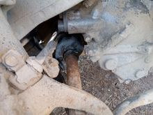 It is supposed to be connected to this sensor being pointed to with a phillips screwdriver. It's in the right side fender well, on the end of the automatic transmission.