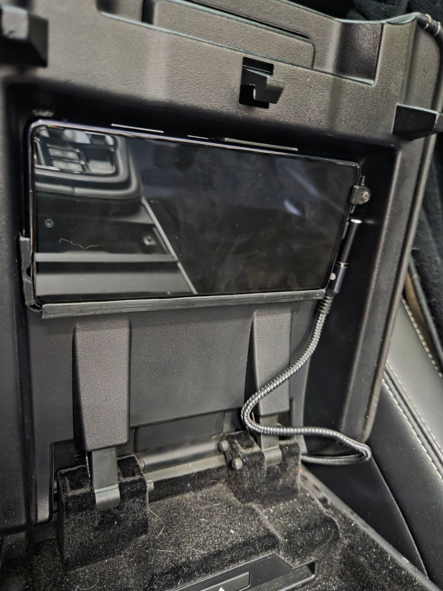 Phone mounted under the console lid. 