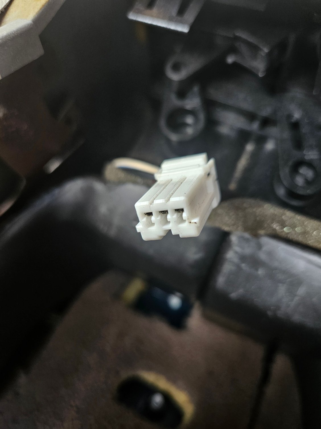 The connector I can only assume is the cigar lighter connector for the VPD trimp rear vent.