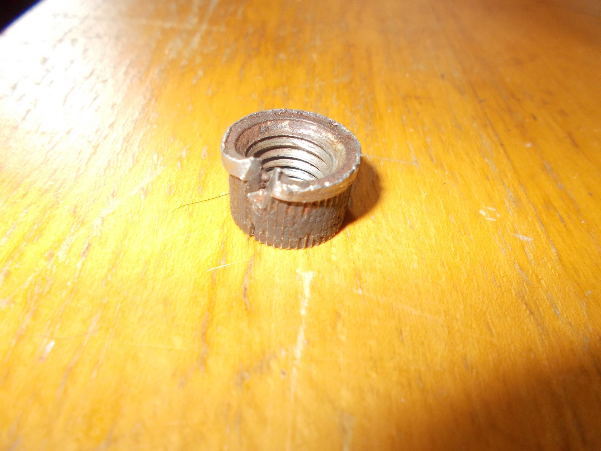 The knurled flat rivet nut that eventually died a dogs death . . . No offence to any pooch's intended . . . you can still see that the ribbing is crudded with plastic where its twisted free!! 