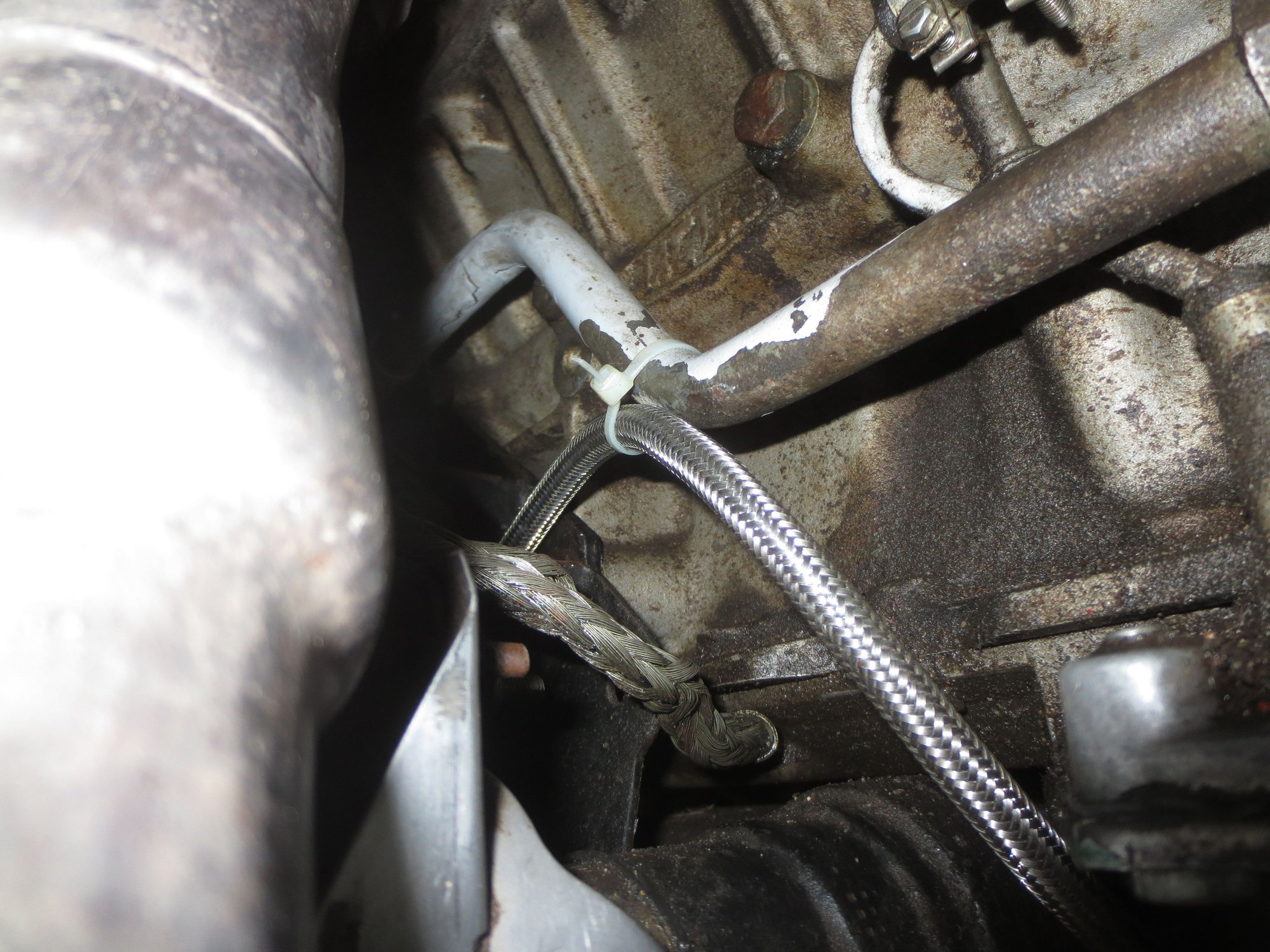 Ties to oil cooler pipe to keep it away from the exhaust