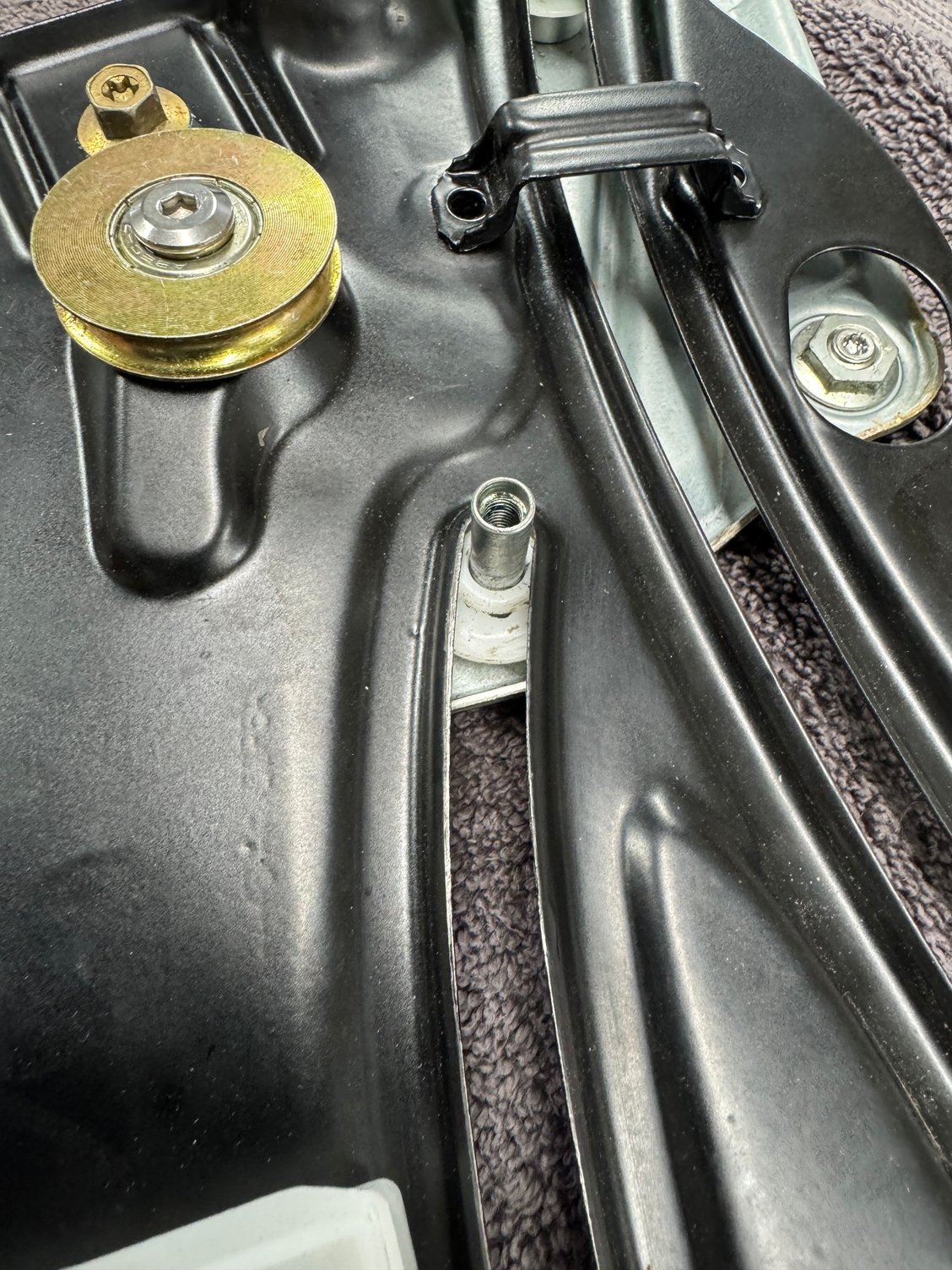 New pulley in position - center glide where the white wire junction box goes was missing the nylon washer/glider.