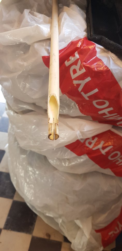 I shaped my own tool out of a plastic electrical pipe. used a small saw to shape it and then heated it with a heatgun and wraped the end around a 10mm drill bit. The long one made it 