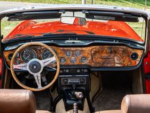 This was the interior of my 73 Triumph.  People used to joke with me that it was a little Jaguar-ish with the leather seat covers, Burled walnut dash, door caps, and matching wood rimmed wheel!