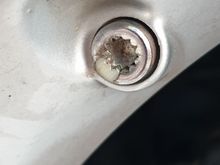 Well, you can see where the coating was lost on my wheel,  that the original is plastic as well ....

unless someone  replaced them before ??
Has anyone a photo of a removed bolt ?