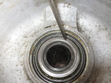 This is the view of the inner side of the hub carrier. The bearings are in it, and the hub has been inserted too. The pointer is on the INNER race of the inner bearing.