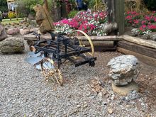 Another view of the memorial garden with an original implement.