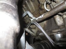 Ties to oil cooler pipe to keep it away from the exhaust