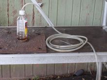 Home made Bleeder.
All you need is a Bottle and a Piece of Tube
Make sure the end in the Bottle is submersed in Brake Fluid so it can't draw any Air Back.
The reason for the Long Tube is so I can position the Bottle where I am able to see it while sitting in the Car.