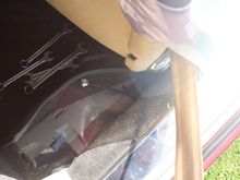 Location of Handbrake Adjustment Rod behind the drivers seat very close to the sill where that Spanner is sticking up