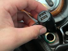 The Essgoo power wire heads straight into a 12-V cigarette lighter outlet and includes two USB ports for phone charging. I'm considering tapping it directly into the car's wiring if I find this annoying. 
