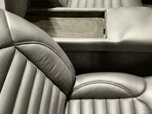 Center cubby, a place to put the smartphone and little else. 