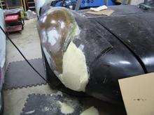 Then we removed the bag and started shaping with a crosscut saw (now were on the passenger side)  the pour foam shaped nicely and gave us a smooth contour despite the lousy fitment of the rear quarter panels.  Here is the quarter panel part way through the shaping process.  I know, it looks horrible and rough but...it's the finished product that counts, right?