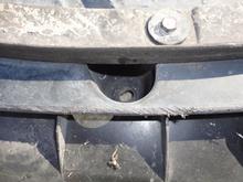 There are a number of fasteners attaching the under tray.  In addition to the connectors that you see attaching the front of the under tray to the front bumper cover, there are additional fasteners in recesses.  When you think every fastener has been removed, the tray slides to the rear to unhook from the bumper cover.