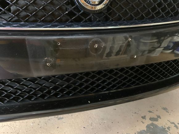 All the holes in the front bumper from the bracket - and too-long plate screws