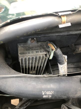 What is this part? Front right of engine bay between battery box and radiator. 
I have the dreaded not charging light on, changed alternator after checking and getting 11.2 out between output post and negative battery terminal and engine bay ground. Leads are checked out ok, same issue with new alternator, both batteries I have for this car are tested good, with high CCA. The 4 pin plug to the alternator is clean. Is this in the charging/regulator circuit?