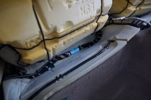 Cable ties hold HDMI cable (black and silver) to wire bundle