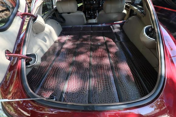 Luggage flooring covered in alligator naugahyde.