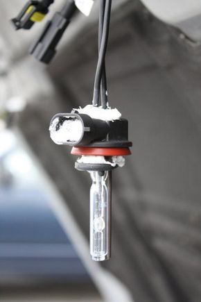 The bulb mount modified with a hole big enough to allow the plug to slide through and then the bulb inserted into the hole and caulked to seal things back up.