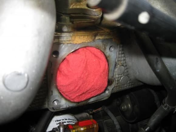 I stuffed some rags into the open intake to keep debris out. The screwdriver is a stubby phillips put in the coolant hose to keep it from leaking while the TB is off.