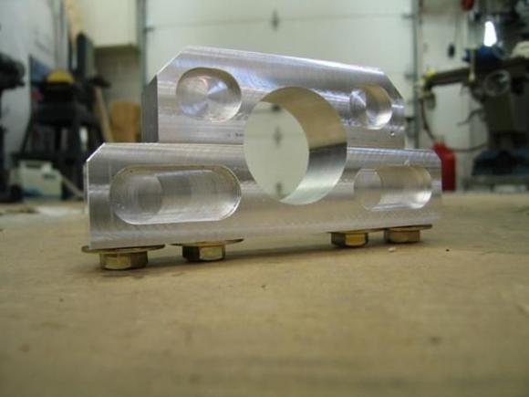 5 12
So, here is the final mounting bracket to hold the steering column with as much metal cut away as I felt comfortable doing w/o loosing too much integrity.  It is installed directly behind the dash and the bolts are accessible from under the dash.  It works just as designed and allows you to adjust the steering wheel position from the dash.  The sad part is that, after all of this work, you can't even see it!