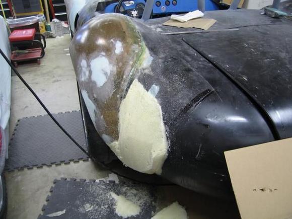 Then we removed the bag and started shaping with a crosscut saw (now were on the passenger side)  the pour foam shaped nicely and gave us a smooth contour despite the lousy fitment of the rear quarter panels.  Here is the quarter panel part way through the shaping process.  I know, it looks horrible and rough but...it's the finished product that counts, right?