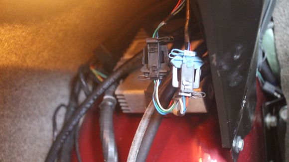 The Speedo Interface 'Black Box' is inside the Boot/Trunk underneath the Fender/Wing
I couldn't get the Camera far enough in there to get a Photo but if you follow the thick wire from the Transducer in the IRS you should eventually find it though it isn't one of those things in the Photo, its further back than that