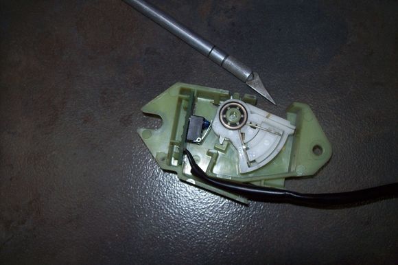 switch's white ratcheting lever fully compressed ready for installation.  Note the gap to the housing. 