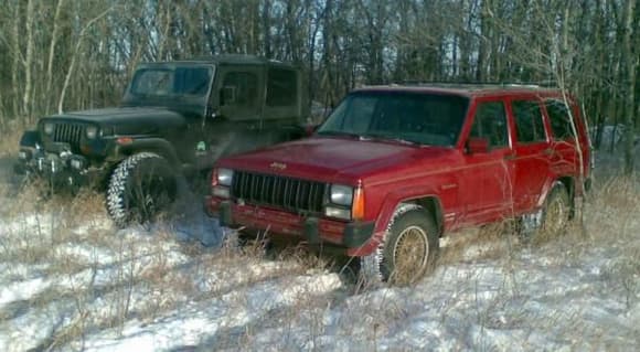 My XJ and my buddies YJ taking a break from playing in the snow just after Xmas. Too damn cold (-30 and wind) to be outside for long and neither one of us would stay out long enough to take pics of the hill climbing we were doing in a gravel pit. I'll get some soon. Showed me you don't want mudders in the winter though. He runs 33&quot; BFG Mud T/As and I run 235/70 Hankook A/Ts. I was out climbing him everywhere we went. He's switching back to his A/Ts for the rest of the winter real soon.