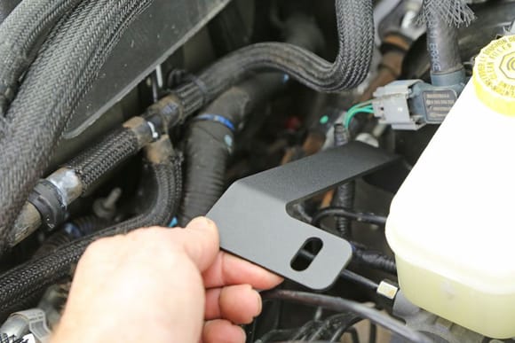Install the brace up against the master cylinder flange.