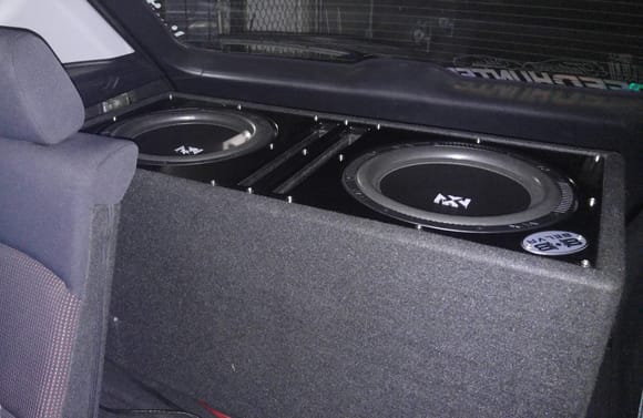 Put my subs from my old car into the trunk. 2x NVX NSW122v2 in a Belva BBX212BK, powered by NVX JAD900.5 (440 watts @ 2ohms)