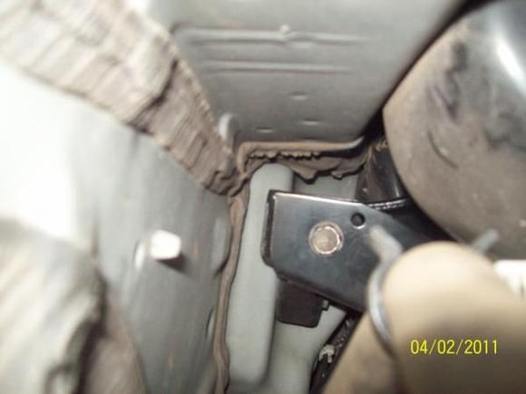 Passenger side (right side) looking from the rear of the vehicle at the inboard bolt. remove the black hose from the clamp and with a 10 inch extension you will be able to get to it with ease.