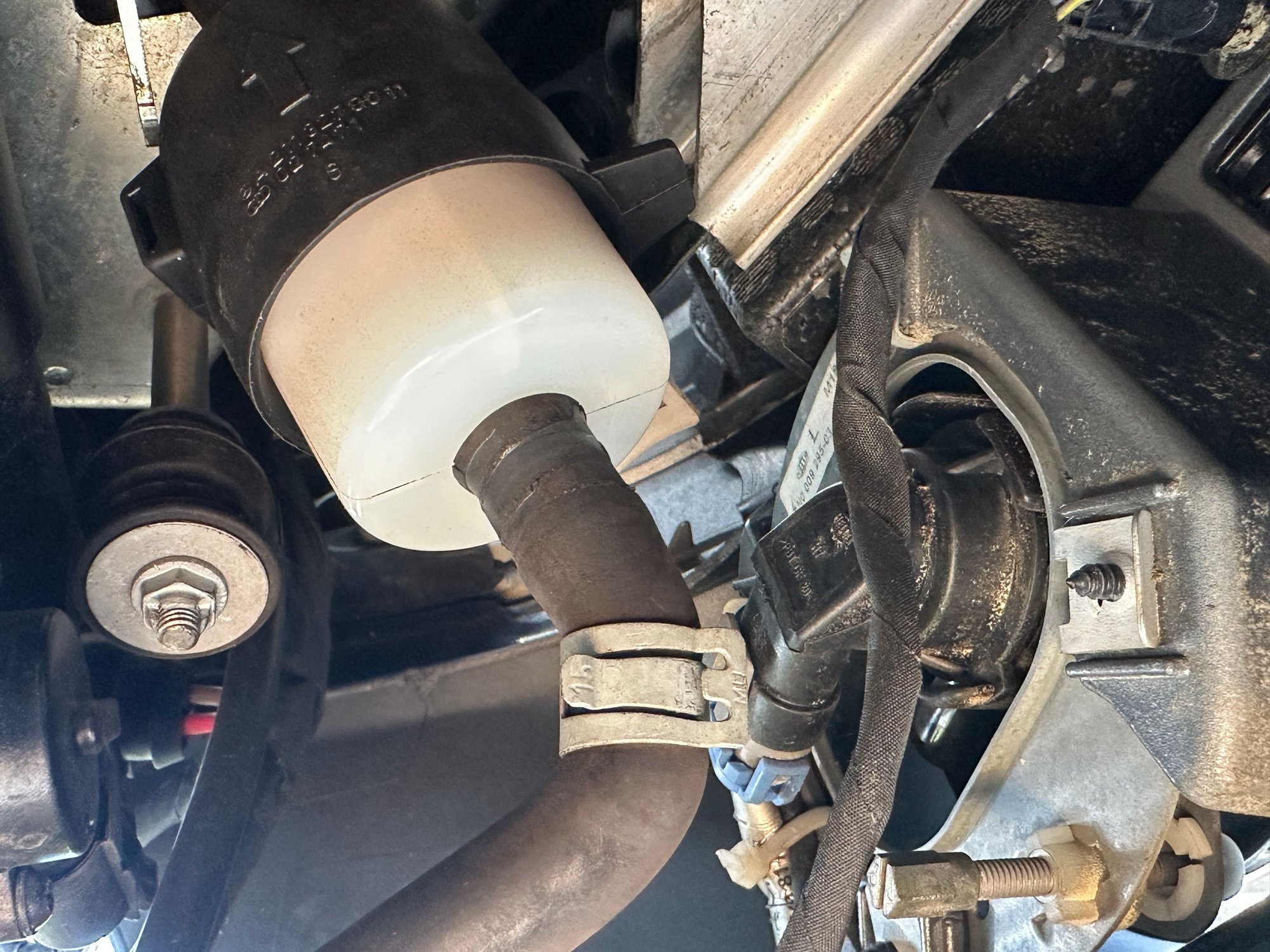 Close-up of the removed clamp on the filter hose.