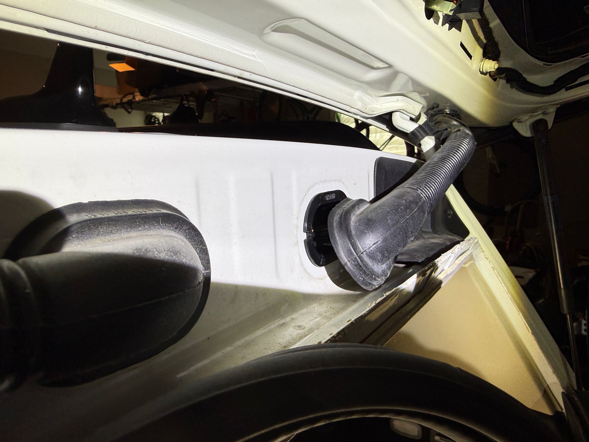 Passenger side rubber boot detail for wiring loom routing. 