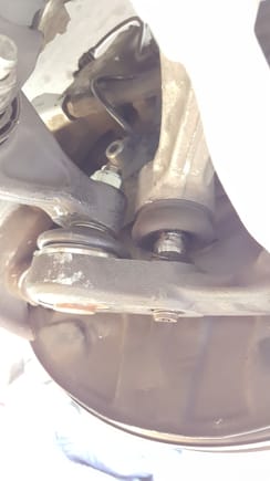 ball joint has been successfully separated. Once the joint is separated take off the front and middle under panels of the vehicle with a 8mm socket.