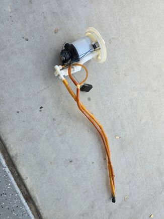 This is the fuel pump sending with the sending unit completely removed. I wanted to make sure that I laid it out so that when I ordered the new part it would look exactly like this. Please note that this unit does not have any wires with it just the two hoses