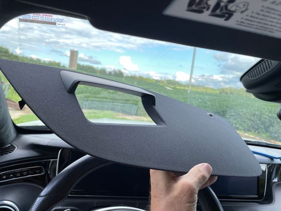 Pry up at the lower right corner and work out towards the drivers door along the lower (closer to you on the dash) edge.  Pry up and pull the whole thing towards you to unhook the edge that runs along the windshield.  Disconnect the sunlight sensor before trying to clear the trim piece away from the area.