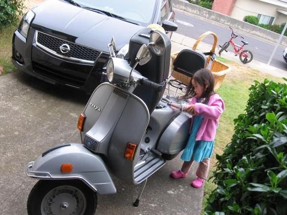 1980 Piaggio Vespa P200e.  My little girl learning about two-stroke maintenance.