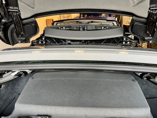Lower roof into trunk, and use convenience button to lift roof upright. You will see the failed fastener glue, yellowish dots